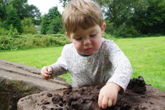 Young child playing with soil