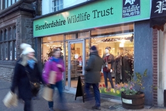 Shop front with people walking past