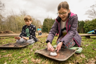 Boy and girl creating a campfire