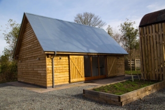 Timber building with large window and sloped roof