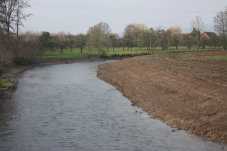 River with bare earth bank