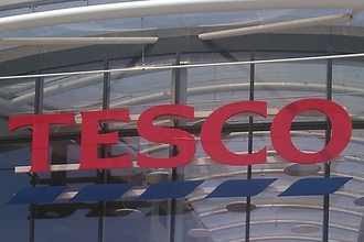 Tesco lettering on outside of glass building