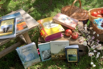 Tangled Tales books scattered in orchard