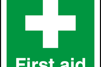First aid symbol with white cross on green background