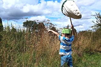 Boy with sweep net at Bartonsham Meadows