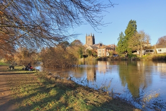 View of river with cathedral and other buildings on far bank