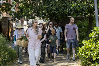 Group of people walking through a garden
