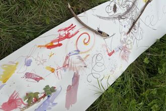 children's colourful paintings on a long roll of paper