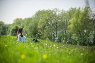 woman sitting in meadow