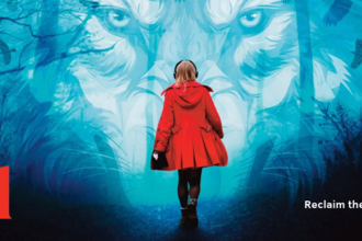 Girl in red coat walking towards the face of a wolf in the dark with woodland edge