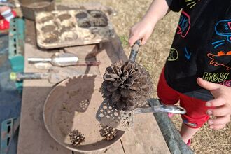 Child playing with a mud kitchen