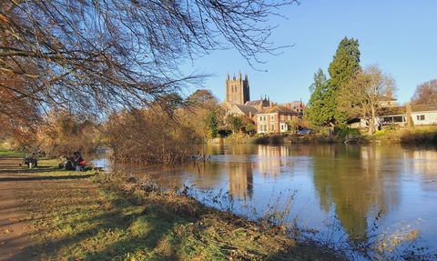 View of river with cathedral and other buildings on far bank
