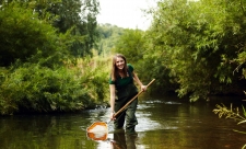 Girl with pond net in river