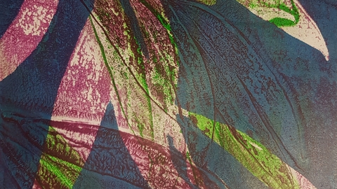 Abstract print with pink and green shapes over dark blue background
