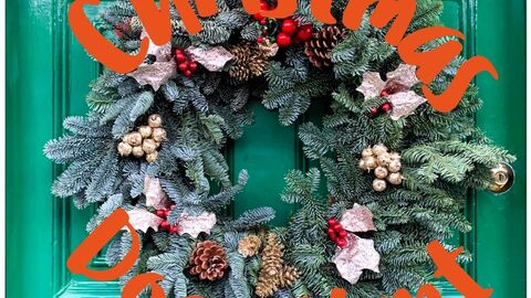 Trail poster with photograph of a green door with a festive Christmas wreath