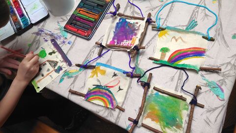 colourfully painted mini canvases with rustic stick frames