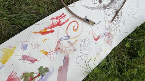 children's colourful paintings on a long roll of paper