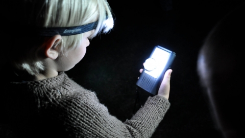 Young boy holding a bat detector