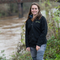 Young woman stood in front of wide river