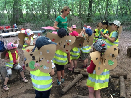 Group of children with handmade cardboard wings