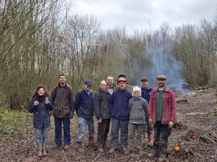 Group of people stood in woodland clearing