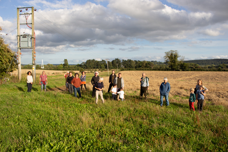Group of people stood in meadow