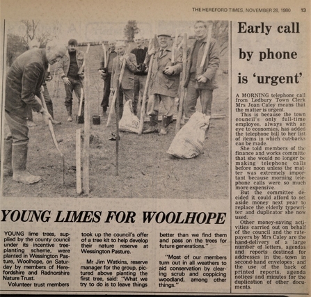 Newspaper clipping with photo of group of men watching a man plant a tree.