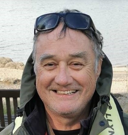 Headshot of man with sunglasses in his head