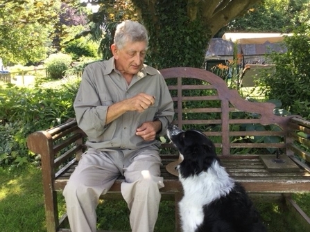 paul on bench with dog