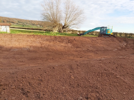 Bare earth with digger in background