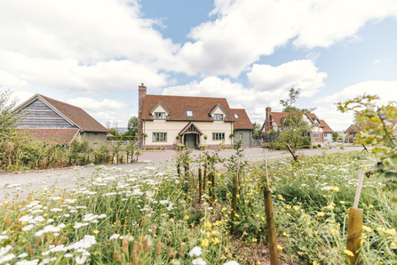 border oak house with greassland meadow infront 