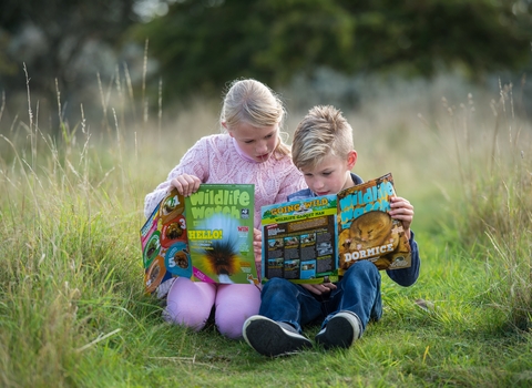 children reading Wildlife Watch magazine